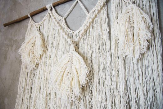 Wall panel in the style of Boho made of cotton threads in natural color using the macrame technique for home decor and wedding decoration. Beautiful boho macrame wall panel will add a cozy atmosphere and charm to any space in your home