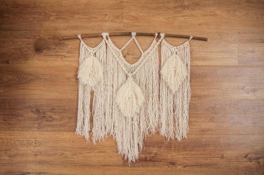 handmade macrame mural hanging on the wall