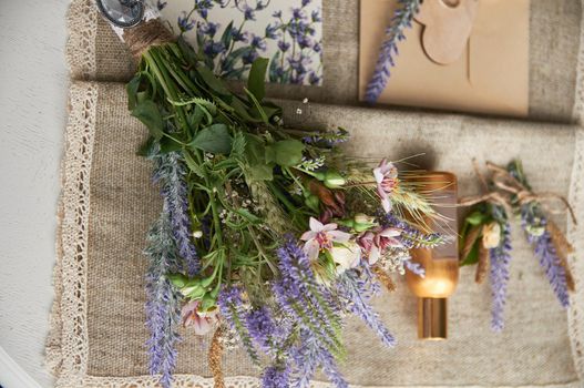 boho style wedding bouquet on table with linen tablecloth