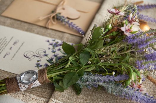 boho style wedding bouquet on table with linen tablecloth