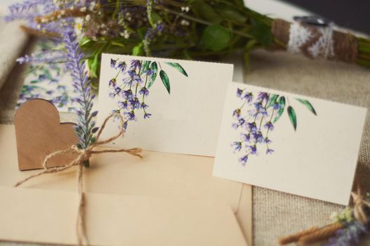 cards for lettering names blank, envelope on table with lavender flower