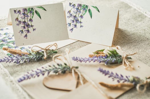 cards for lettering names blank, envelope on table with lavender flower