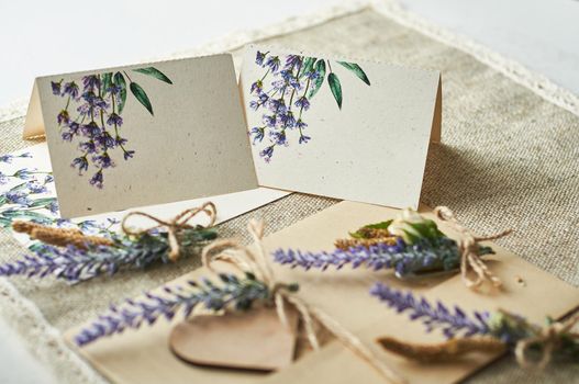 cards for lettering names blank, envelope on table with lavender flower