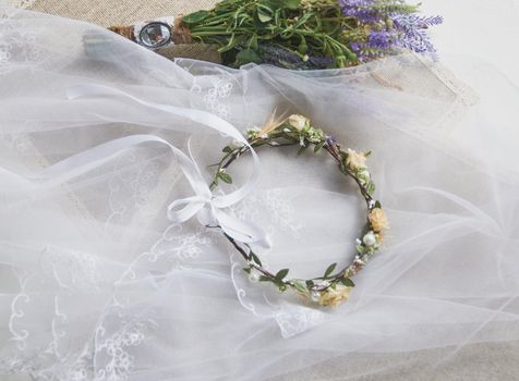 wedding wreath on table with lavender bridal bouquet