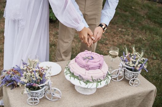 butter cake in rustic style on the holiday table cut the bride and groom