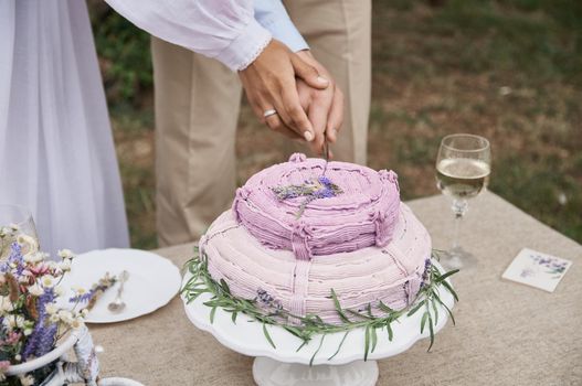 butter cake in rustic style on the holiday table cut the bride and groom