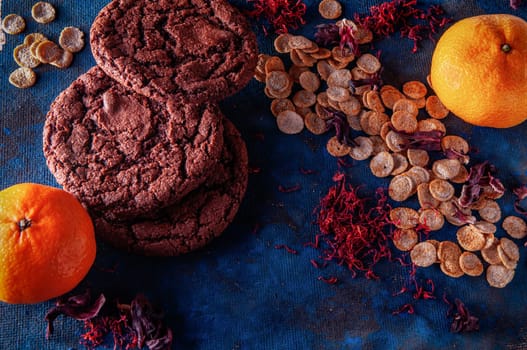 still life on a blue background with american dry crispy cookies and tangerines