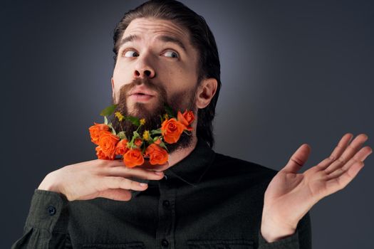 portrait of a man flowers in a beard decoration romance black background. High quality photo