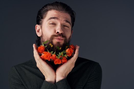 portrait of a man flowers in a beard decoration romance black background. High quality photo