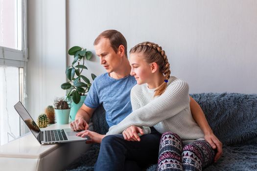 Father and daughter having video call with grandparents on laptop during covid quarantine lockdown. Stay at home, distance communication concept