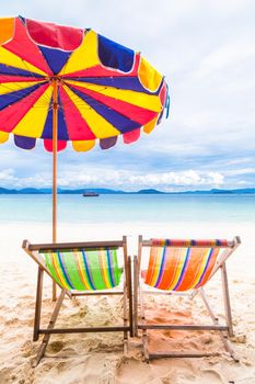 Two colorful beach chair with umbrella on the beach