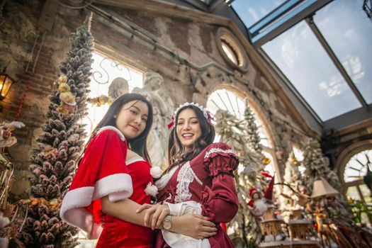 Young woman in red santa costume, Girl celebrates New Year 2021 in winter. Shopping black friday sale concept