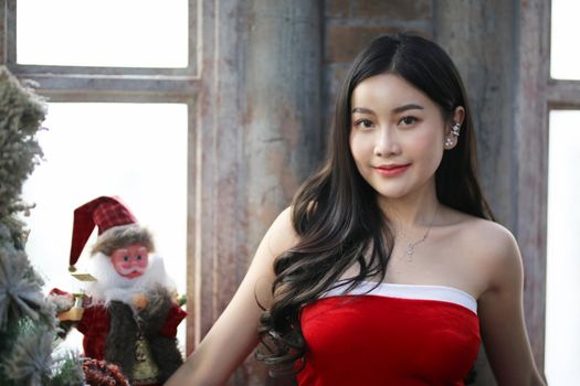 Young woman in red santa costume, Girl celebrates New Year 2021 in winter. Shopping black friday sale concept