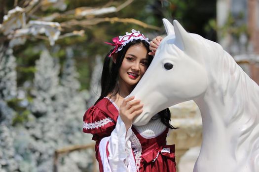 Young woman enjoying ride go around in the amusement park.