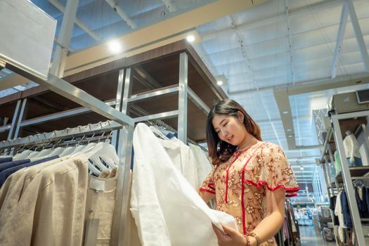 woman choosing clothes in shop