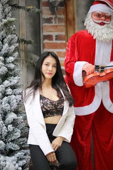 Portrait of young beautiful woman in winter clothes. while posing on snow background. Outdoor close-up photo of female model with romantic smile chilling in park in winter.