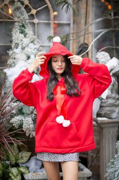 Young woman in red santa costume, Girl celebrates New Year 2021 in winter. Shopping black friday sale concept
