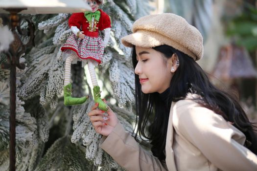  Portrait of young beautiful woman in winter clothes. while posing on snow background. Outdoor close-up photo of female model with romantic smile chilling in park in winter.