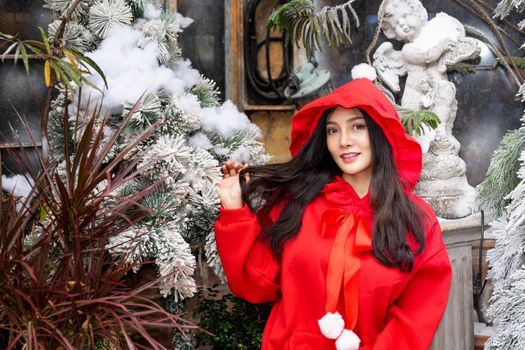 Young woman in red santa costume, Girl celebrates New Year 2021 in winter. Shopping black friday sale concept