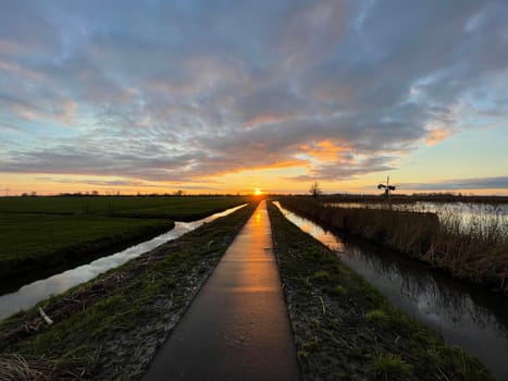 Sunset on a path towards IJlst in Friesland The Netherlands