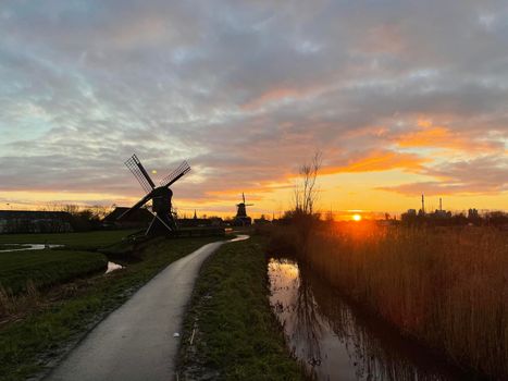 Windmills during sunset in IJlst, Friesland The Netherlands