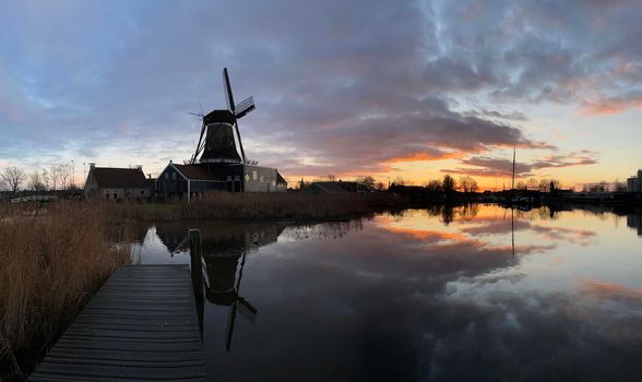 Windmill in IJlst during sunset in Friesland The Netherlands
