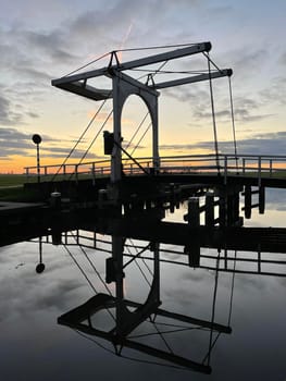 Bridge reflection in IJlst during sunset in Friesland The Netherlands