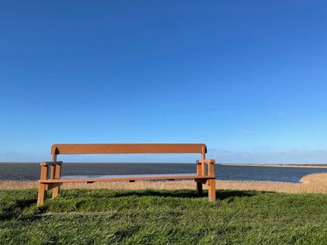 Bench at the dyke of the IJsselmeer around Gaast in Friesland, The Netherlands