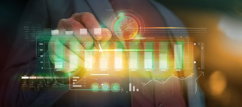 Augmented reality in which a businessman in a suit works with a stylus with a panel of stock charts.