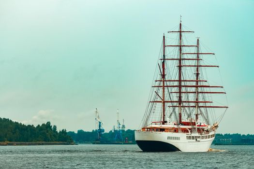 Big white sailing ship with three mast moving to the Riga port