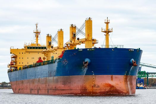 Blue cargo ship entering the port of Riga, Europe