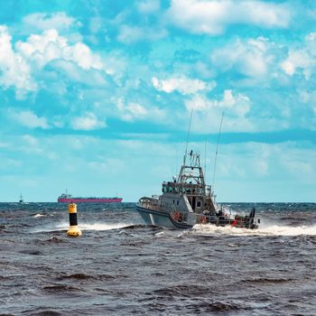 Grey military ship sailing at Baltic sea. Border guard service