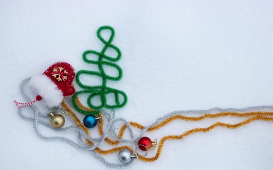 Red mitten lying in the snow in the winter. Festive decoration. Christmas and new year traditions.