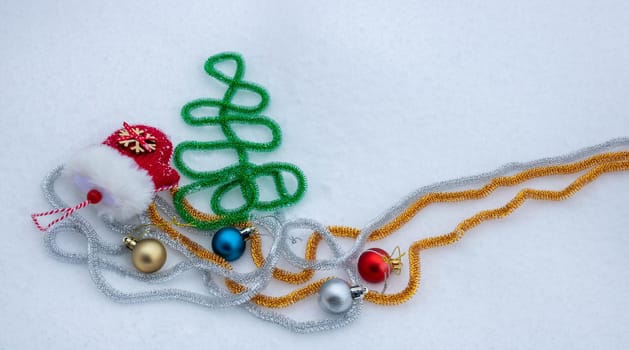 Red mitten lying in the snow in the winter. Festive decoration. Christmas and new year traditions.