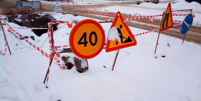 Traffic signs during repair work. Road repairs on city street.