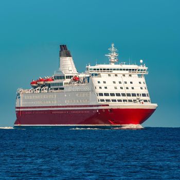 Red cruise liner. Large passenger ferry underway