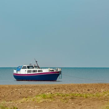 Small blue passenger ship moored at Baltic sea bay