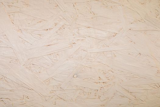 Fragments of glued boards from wood chips. Chipboard beige, wood texture. Wood recycling concept