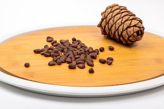 The fruit of Siberian cones - pine nuts on a kitchen cutting board, is a delicious, nutritious and healthy product.