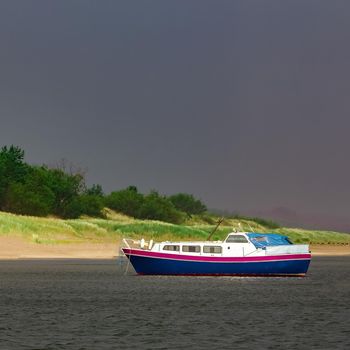 Small blue passenger ship moored at Baltic sea bay