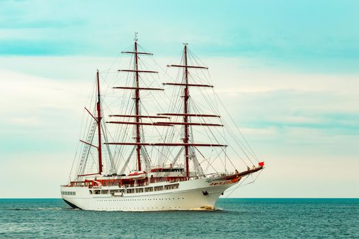 Big white sailing ship with three mast moving to the Riga port