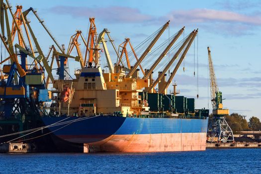 Blue cargo ship loading in the port of Riga, Europe