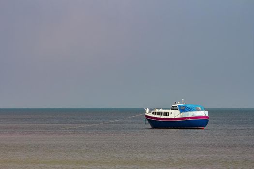 Small blue passenger ship moored at Baltic sea bay