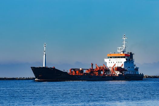 Black cargo oil tanker sailing in still water from Baltic sea