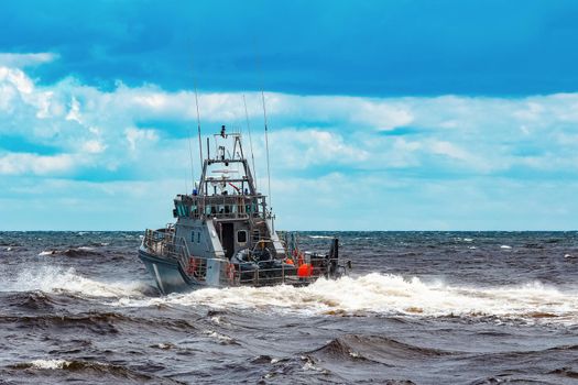 Grey military ship sailing at Baltic sea. Border guard service