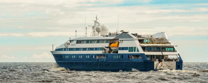 Small blue passenger ship sailing in Baltic sea. Spa services