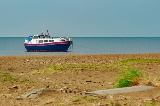 Small blue passenger ship moored at Baltic sea bay