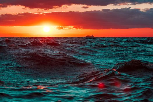 Waves in the ocean against hot and romantic sunset