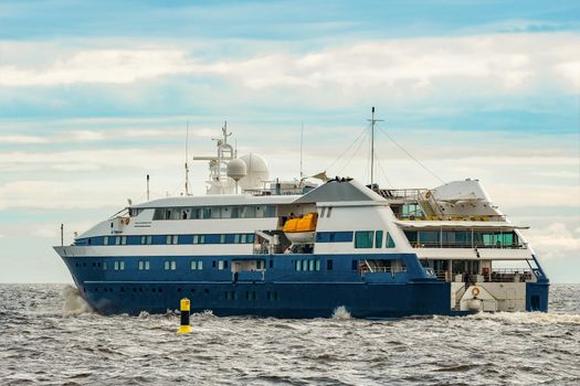 Small blue passenger ship sailing in Baltic sea. Spa services