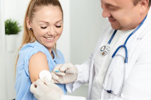 doctor giving injection to woman hospital health lifestyle. High quality photo